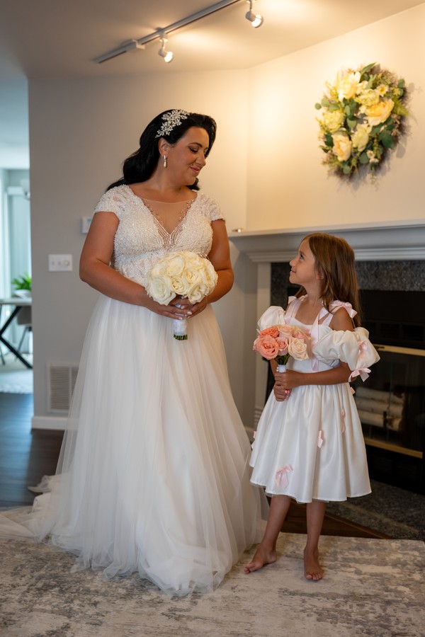 The bride and a flower girl with their bouquets