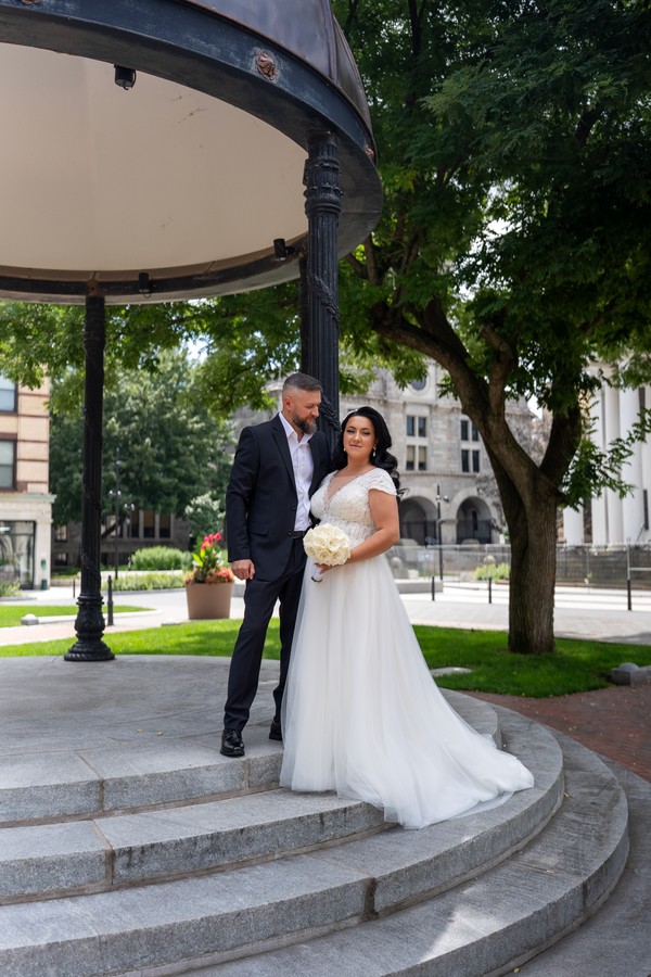 The couple standing together on the pavilion steps