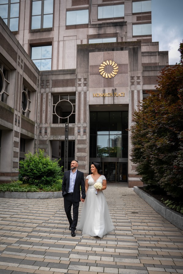The couple walking together through a city courtyard