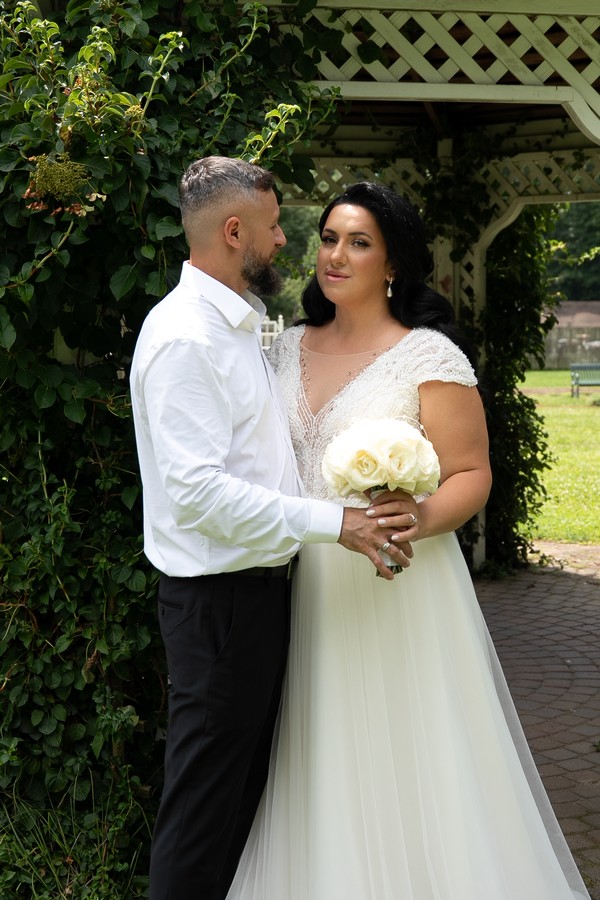 The couple together beneath the garden arbor