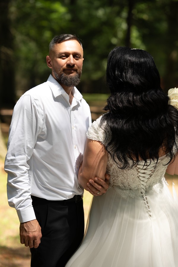 The couple sharing a smile in the garden