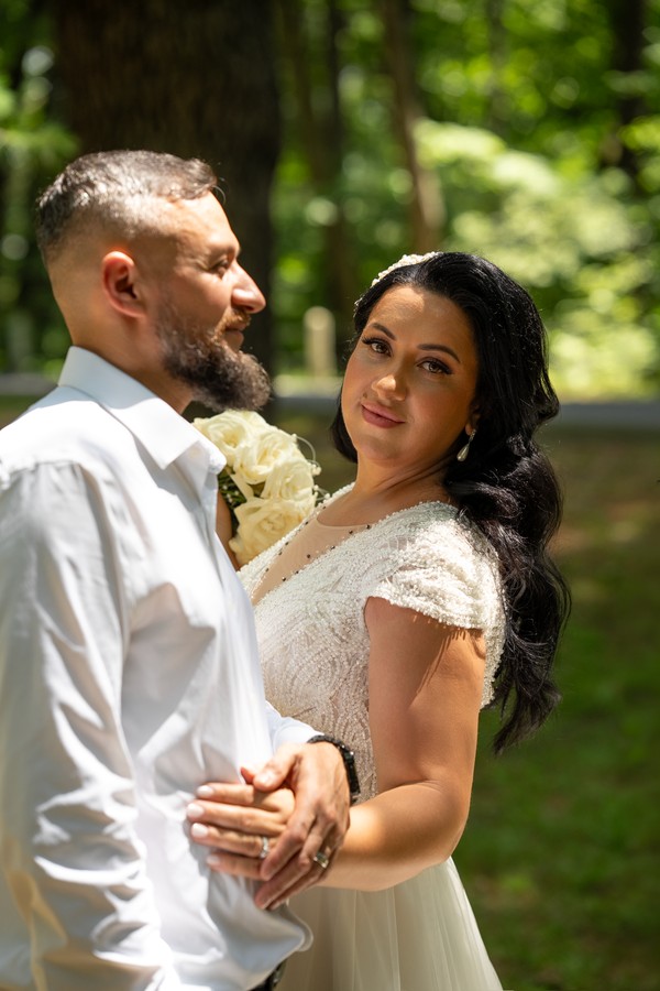 A close portrait of the couple among the trees