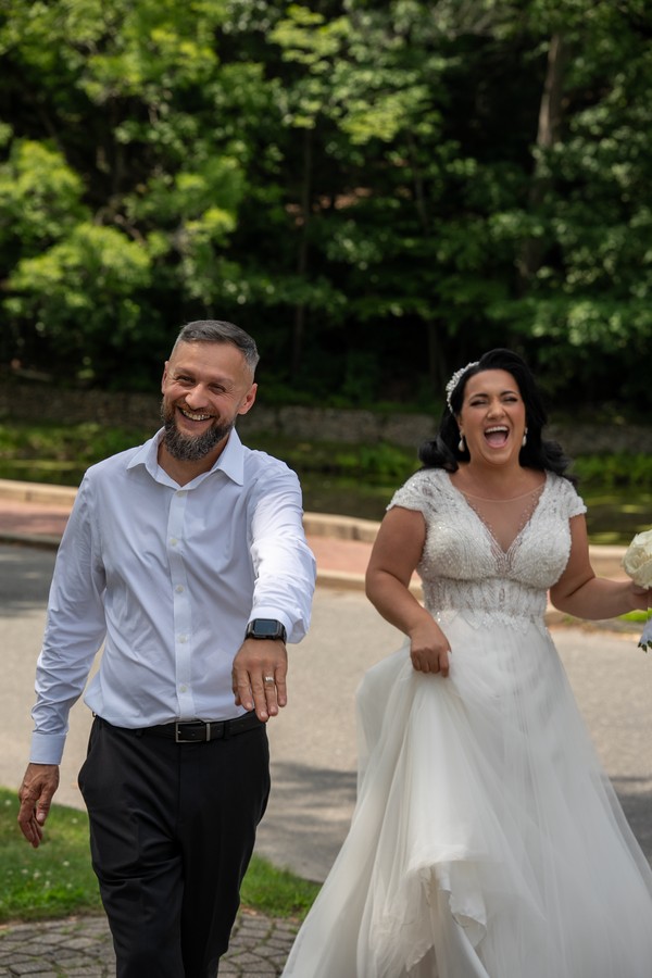 The bride and groom laughing as they walk together