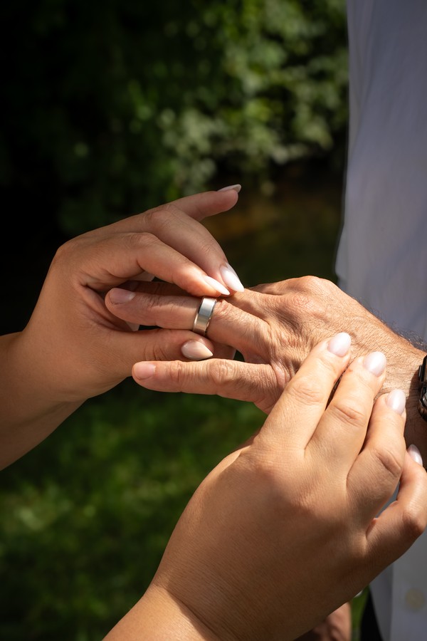 A close detail of the wedding ring exchange